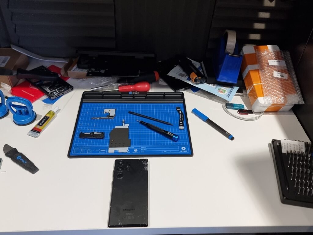 Professional smartphone repair setup with precision tools for fixing broken screens, batteries and components for customers in Hampshire